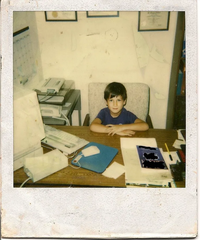 A young Patrick Dobbins sitting in his father's chiropractic office